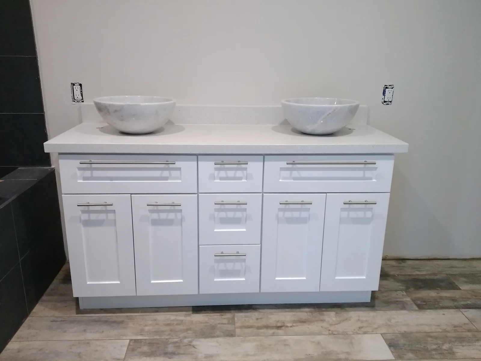 White cabinetry vanity with dual marble vessel sinks, quartz countertop, and chrome fixtures